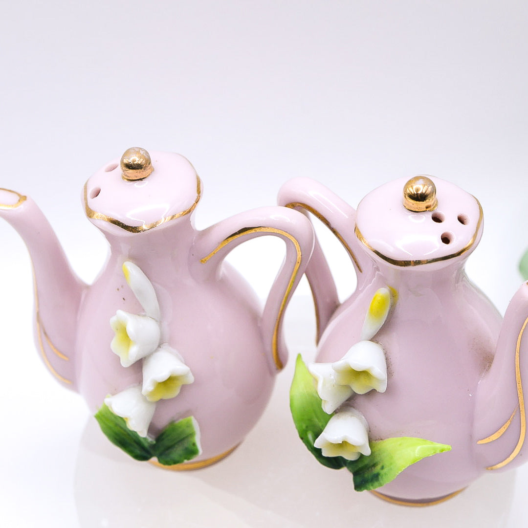 Top of Pair of pink ceramic teapots with floral designs