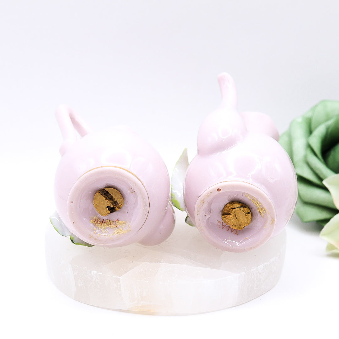 Cork Base of Pair of pink ceramic teapots with floral designs.