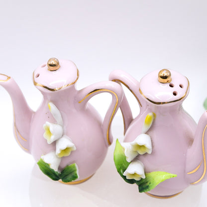 Top of Pair of pink ceramic teapots with floral designs 