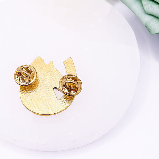 Back view of vintage golden horseshoe lapel pin