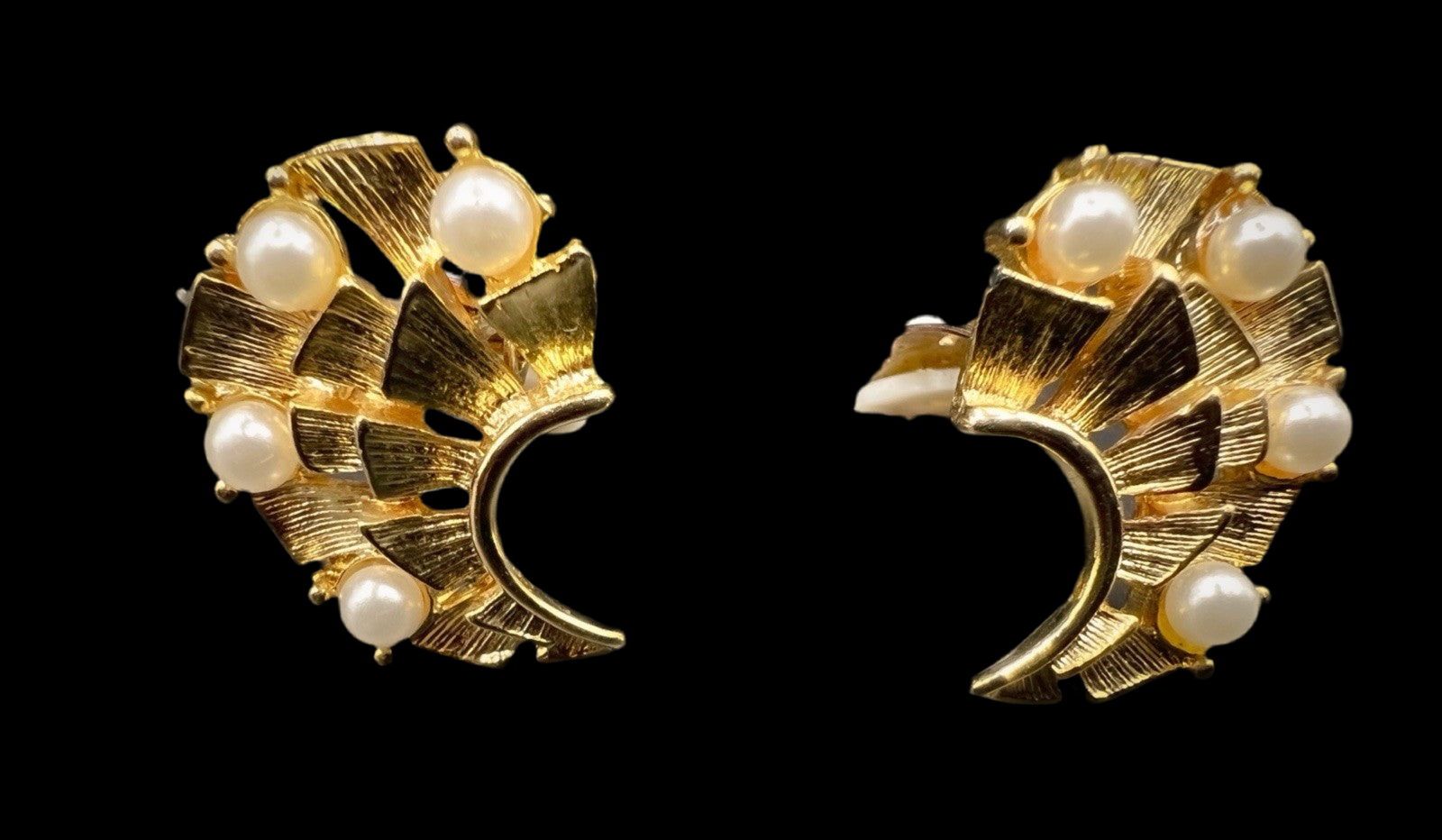 Angled front view of both vintage gold-tone earrings with elegant crescent-shaped open design and pearl embellishments.